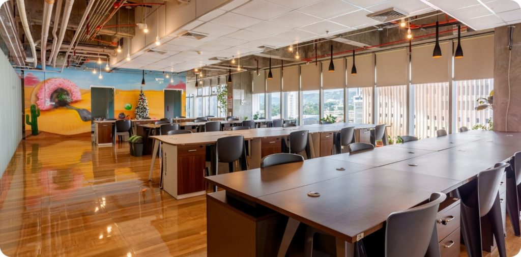 Spacious and modern co-working space in Cebu IT Park with natural lighting, artistic murals, and clean desk setups.