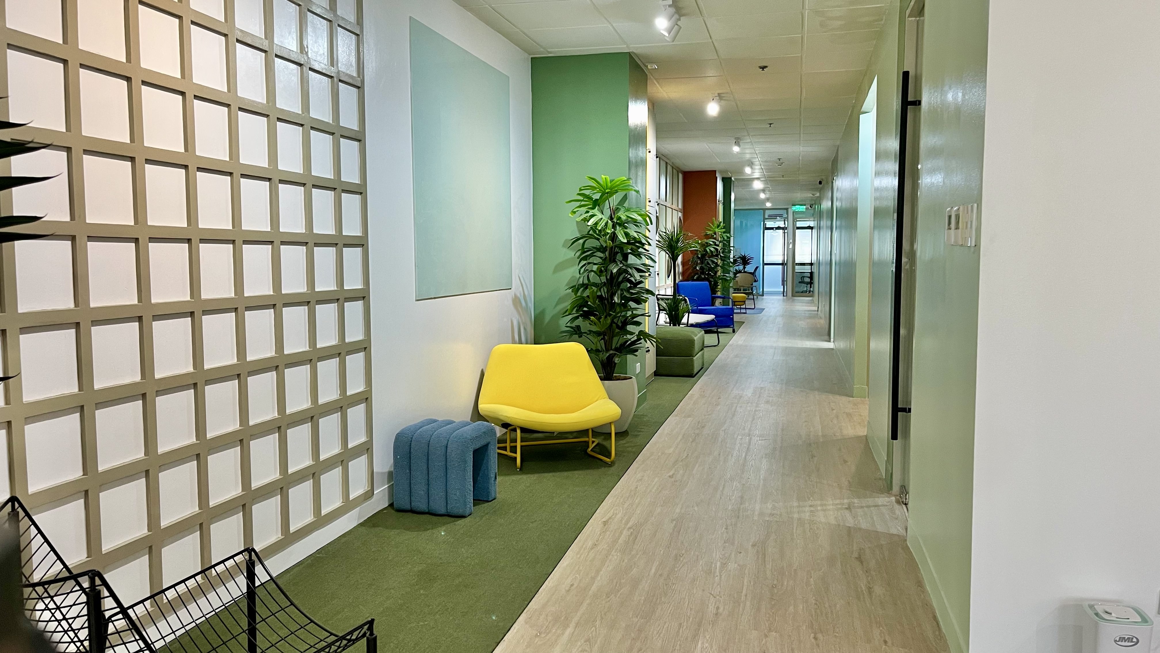 Modern hallway at Zero-ten Park with warm lighting, clean lines, and minimalistic design, leading to private offices and shared coworking spaces offering EOR and recruitment.