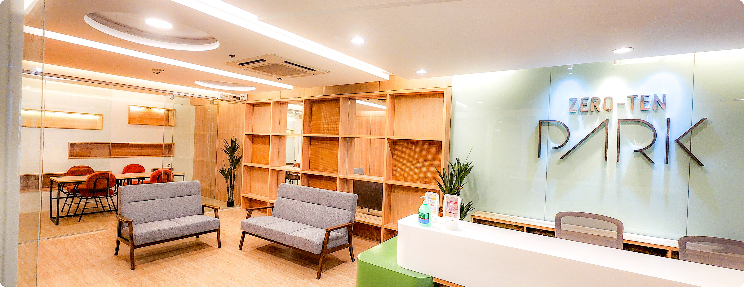 Reception area and meeting room of Zero-Ten Park, a Virtual Office in Makati, featuring minimalist interiors, soft lighting, wood accents, and a professional yet welcoming ambiance for remote teams and business registrations.