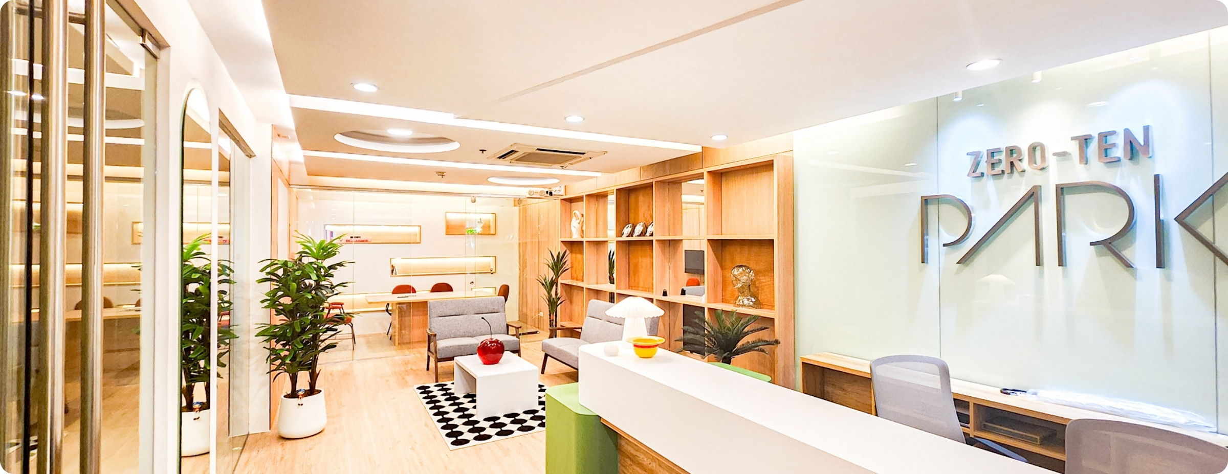 Modern reception area at Zero-Ten Park, offering fully furnished private offices for rent in Makati with stylish interiors, seating, and greenery.